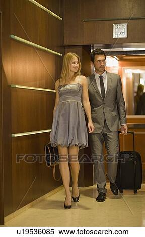 Couple leaving elevator View Large Photo Image Stock Photography - Couple leaving elevator. Fotosearch