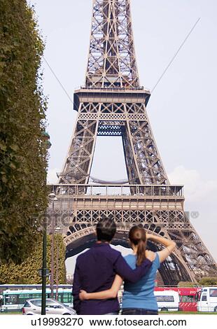 Couple look at Eiffel Tower in Paris View Large Photo Image Stock Image - Couple look at Eiffel Tower in Paris. Fotosearch