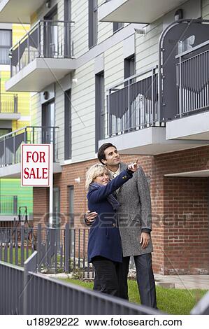 Couple looking at new apartment View Large Photo Image Stock Image - Couple looking at new apartment. Fotosearch