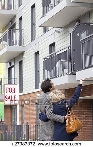 Stock Image - Couple looking at new apartment. Fotosearch