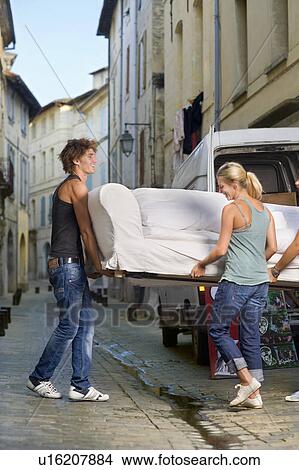 Couple moving sofa in street View Large Photo Image Picture - Couple moving sofa in street. Fotosearch