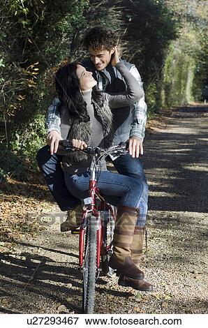 Couple on bicycle View Large Photo Image Stock Photo - Couple on bicycle. Fotosearch