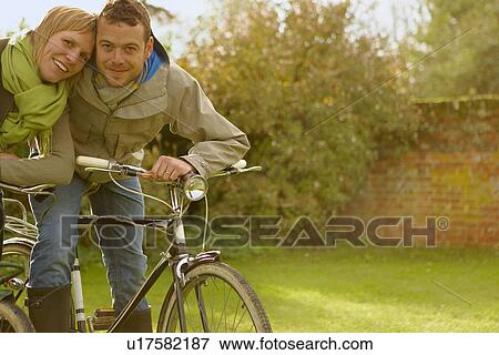 Stock Photo - Couple on old bicycles, embracing. Fall. Fotosearch