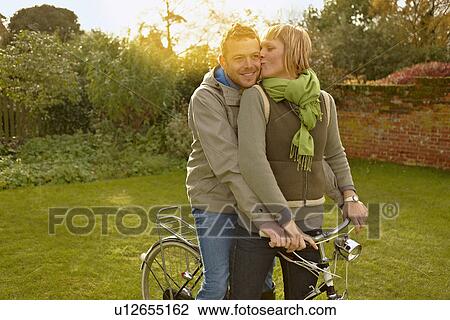 Couple on old bicycles, kissing. Autumn View Large Photo Image Stock Image - Couple on old bicycles, kissing. Autumn. Fotosearch