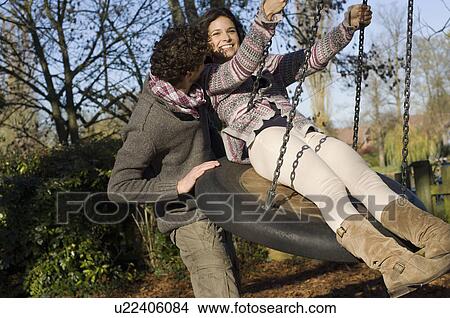 Couple on swing View Large Photo Image Picture - Couple on swing. Fotosearch