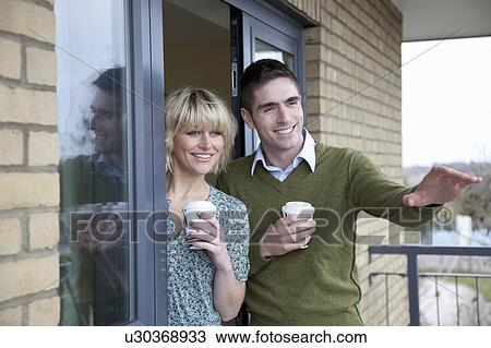 Stock Image - Couple outside their new apartment. Fotosearch