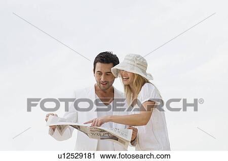Couple reading newspaper View Large Photo Image Stock Image - Couple reading newspaper. Fotosearch