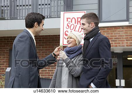 Couple receiving keys from estate agent View Large Photo Image Stock Image - Couple receiving keys from estate agent. Fotosearch