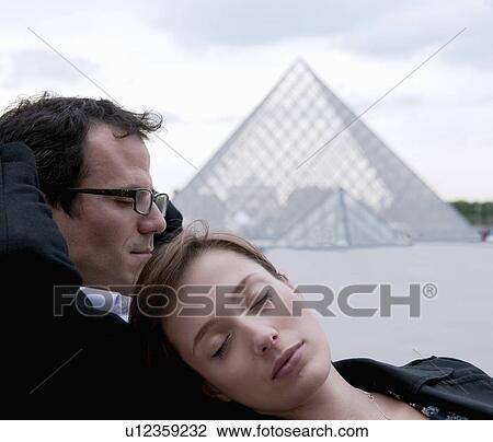 Couple relax outside the Louvre View Large Photo Image Stock Image - Couple relax outside the Louvre. Fotosearch