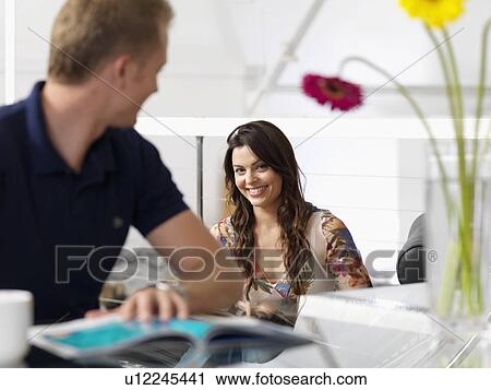 Couple relaxing at home with hot drinks View Large Photo Image Stock Image - Couple relaxing at home with hot drinks. Fotosearch