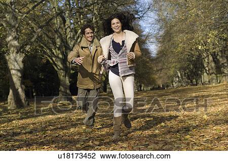 Couple running in wood View Large Photo Image Stock Image - Couple running in wood. Fotosearch