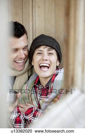 Couple share a hot drink in a hut View Large Photo Image Stock Image - Couple share a hot drink in a hut. Fotosearch