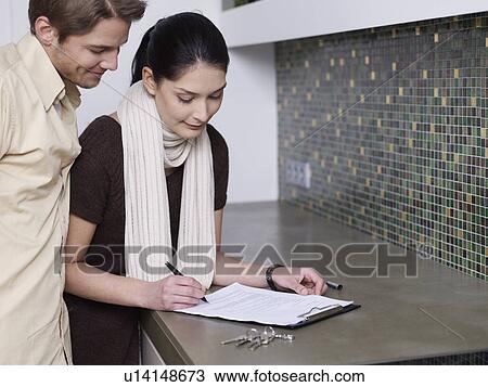 Couple signs tenancy agreement View Large Photo Image Stock Image - Couple signs tenancy agreement. Fotosearch