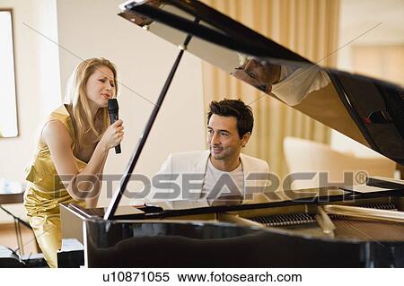 Couple singing and playing piano View Large Photo Image Stock Photography - Couple singing and playing piano. Fotosearch