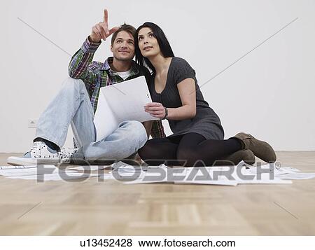 Stock Photo - Couple sitting in empty flat. Fotosearch