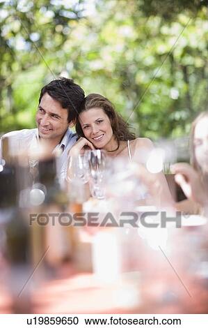 Couple sitting on a celebratory table View Large Photo Image Stock Image - Couple sitting on a celebratory table. Fotosearch