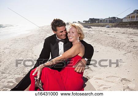 Couple sitting on beach View Large Photo Image Stock Image - Couple sitting on beach. Fotosearch