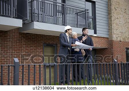 Couple talking to architect View Large Photo Image Picture - Couple talking to architect. Fotosearch