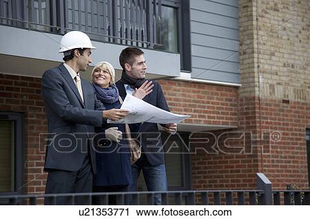 Couple talking to architect View Large Photo Image Stock Image - Couple talking to architect. Fotosearch