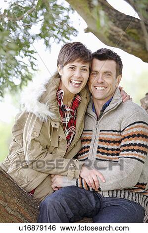 Stock Photograph - Couple together sitting in a tree. Fotosearch