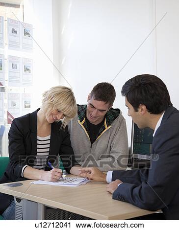 Couple visiting estate agents office View Large Photo Image Stock Image - Couple visiting estate agents office. Fotosearch