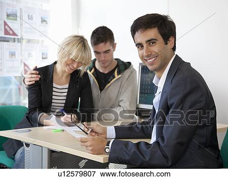 Couple visiting estate agents office View Large Photo Image Stock Photo - Couple visiting estate agents office. Fotosearch