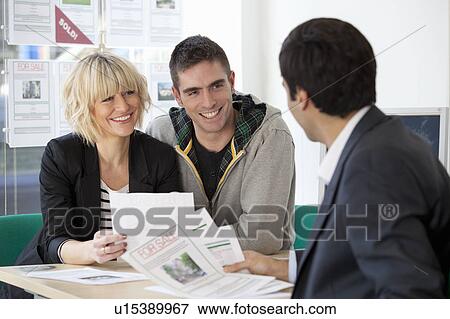 Couple visiting estate agents office View Large Photo Image Stock Photo - Couple visiting estate agents office. Fotosearch