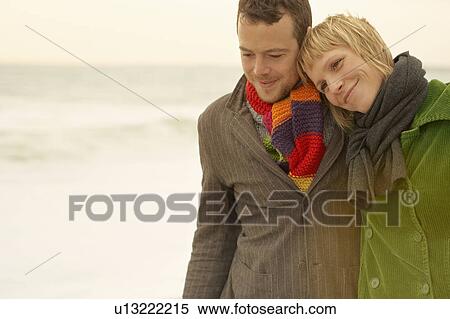 Couple walking and embracing on a beach View Large Photo Image Stock Photography - Couple walking and embracing on a beach. Fotosearch