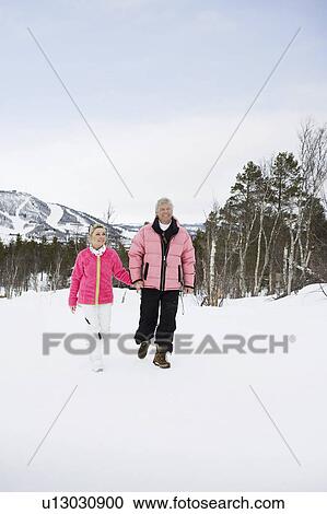Couple walking hand in hand View Large Photo Image Stock Image - Couple walking hand in hand. Fotosearch