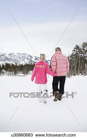 Stock Image - Couple Walking hand in hand. Fotosearch