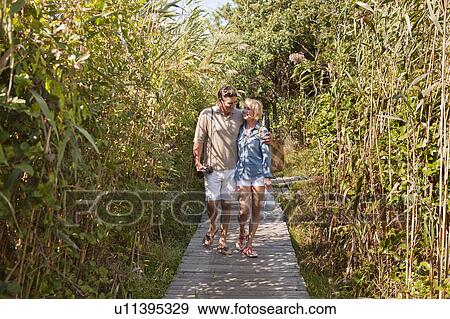 Couple walking together View Large Photo Image Stock Photo - Couple walking together. Fotosearch