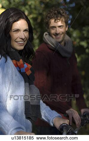 Couple walking with bicycles View Large Photo Image Stock Photography - Couple walking with bicycles. Fotosearch
