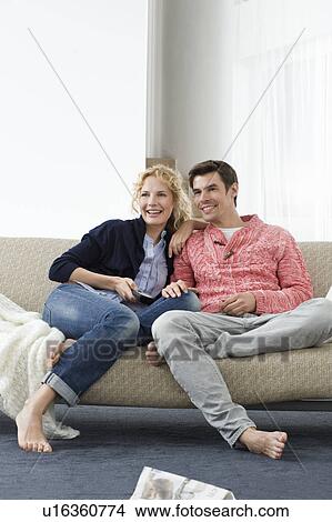 Couple watching tv View Large Photo Image Picture - Couple watching tv. Fotosearch