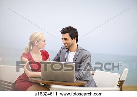 Stock Image - Couple working at laptop. Fotosearch