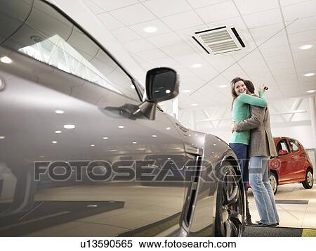 Customers hugging in car dealership View Large Photo Image Stock Photography - Customers hugging in car dealership. Fotosearch