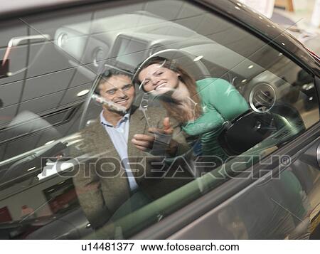 Customers look at car interior View Large Photo Image Stock Photo - Customers look at car interior. Fotosearch