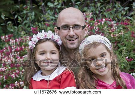 Stock Photograph - Dad and his daughters by honeysuckle. Fotosearch