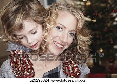 Picture - Daughter hugging mother. Fotosearch