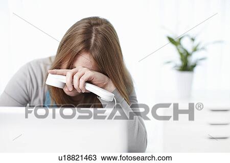 Depressed girl sitting behind laptop View Large Photo Image Stock Image - Depressed girl sitting behind laptop. Fotosearch
