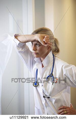 Doctor against a window, thinking View Large Photo Image Stock Image - Doctor against a window, thinking. Fotosearch