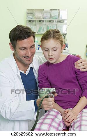 Stock Image - Doctor and girl examining blood pressure. Fotosearch