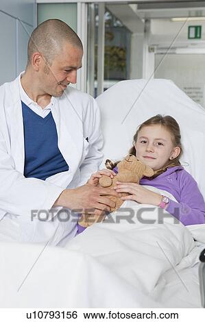 Stock Photograph - Doctor caring about little patient. Fotosearch