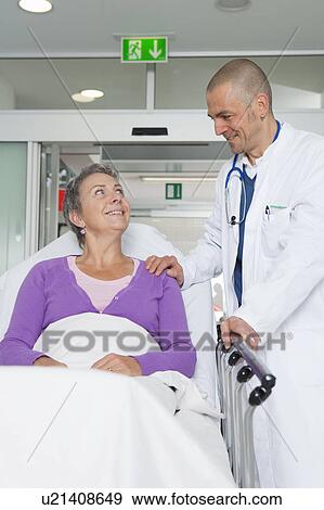 Stock Photo - Doctor caring for elderly woman. Fotosearch