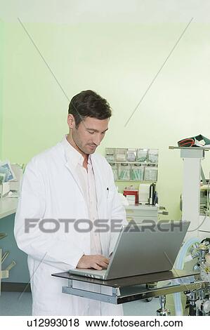 Doctor on laptop View Large Photo Image Stock Photo - Doctor on laptop. Fotosearch