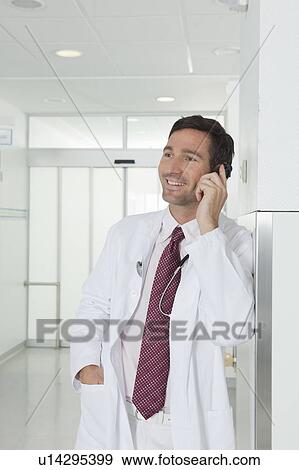 Doctor on the phone in hall View Large Photo Image Stock Photo - Doctor on the phone in hall. Fotosearch