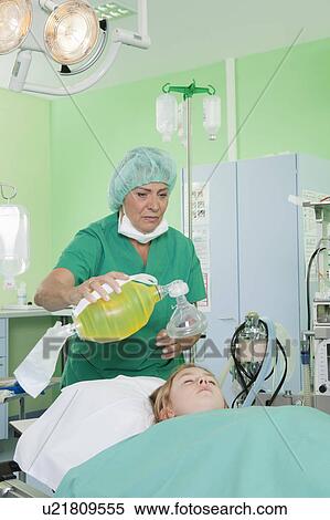 Stock Photography - Doctor preparing respirator for patient. Fotosearch