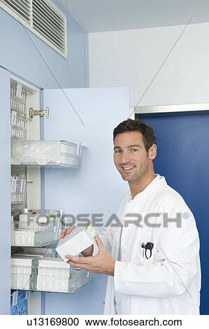 Stock Image - Doctor searching for medication. Fotosearch