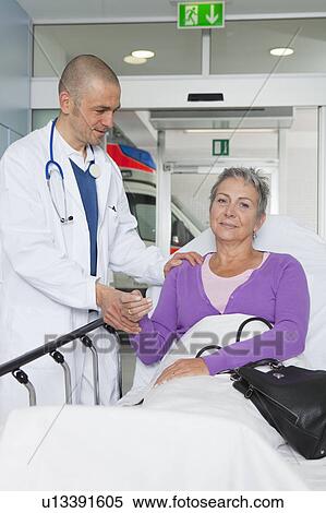 Doctor taking womans pulse View Large Photo Image Stock Photography - Doctor taking womans pulse. Fotosearch