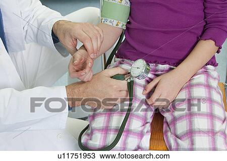 Doctor testing childs blood pressure View Large Photo Image Stock Image - Doctor testing childs blood pressure. Fotosearch