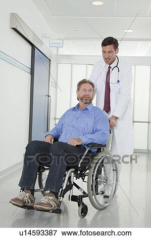 Stock Photo - Doctor with patient in wheelchair. Fotosearch